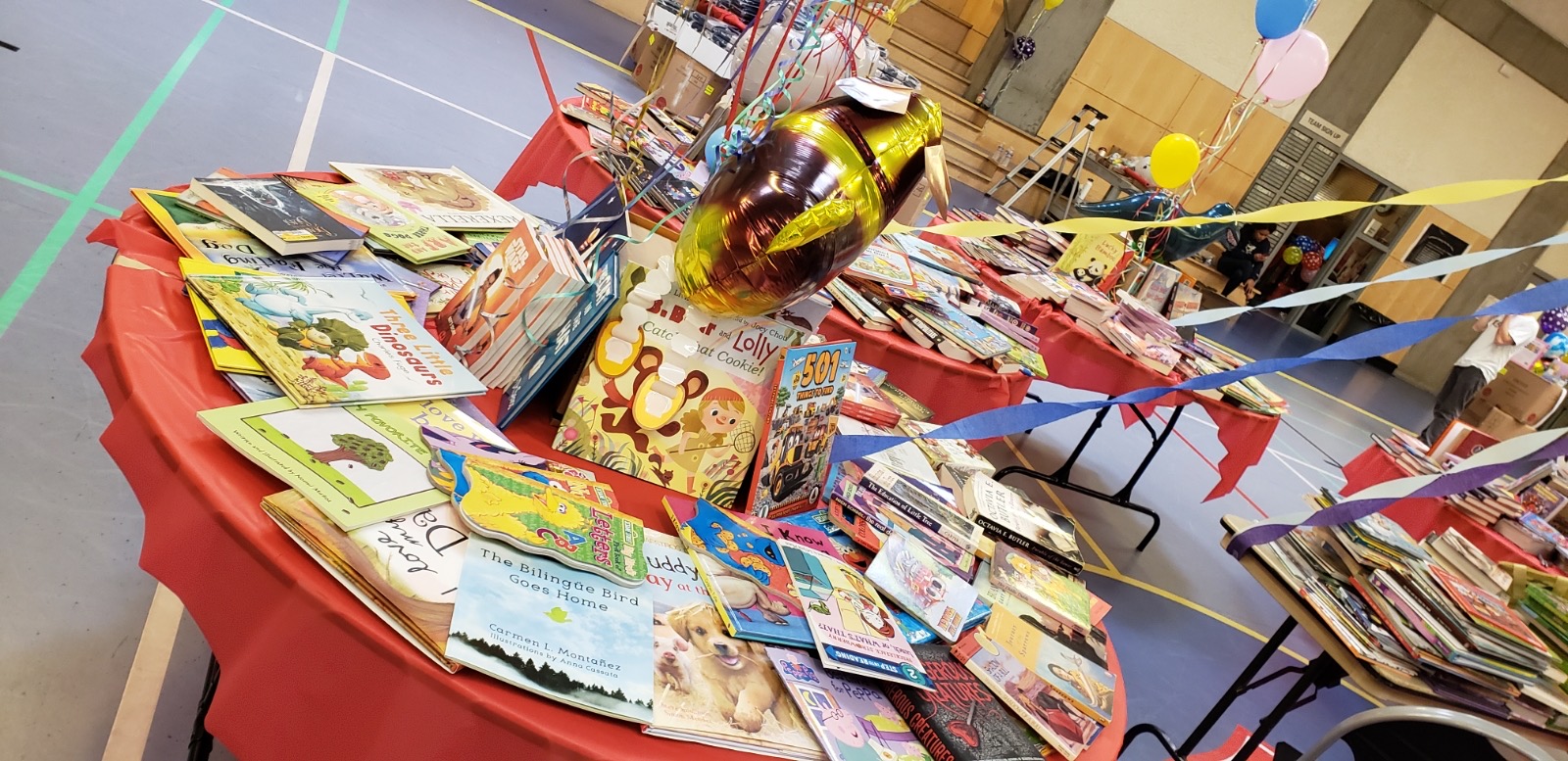 A table covered with books and magazines on top of it.